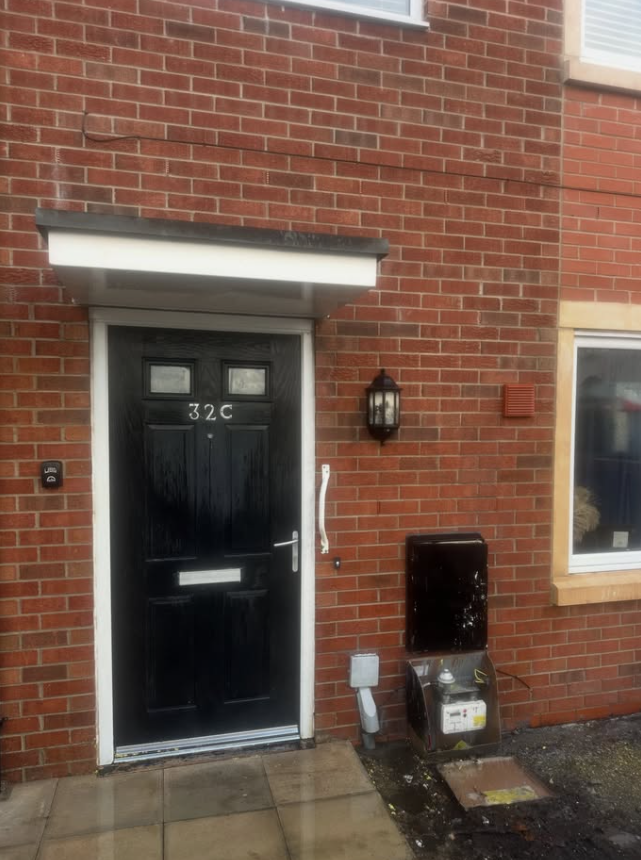 Clean brick wall and front door restored after professional paint removal service