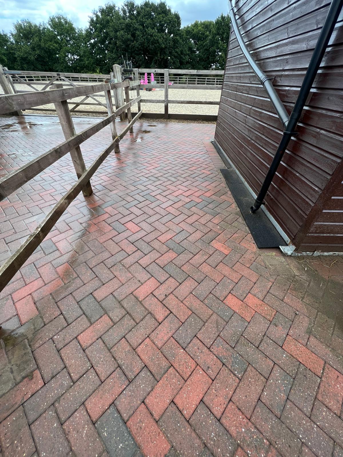 Clean block paving corner area at stables after professional pressure washing