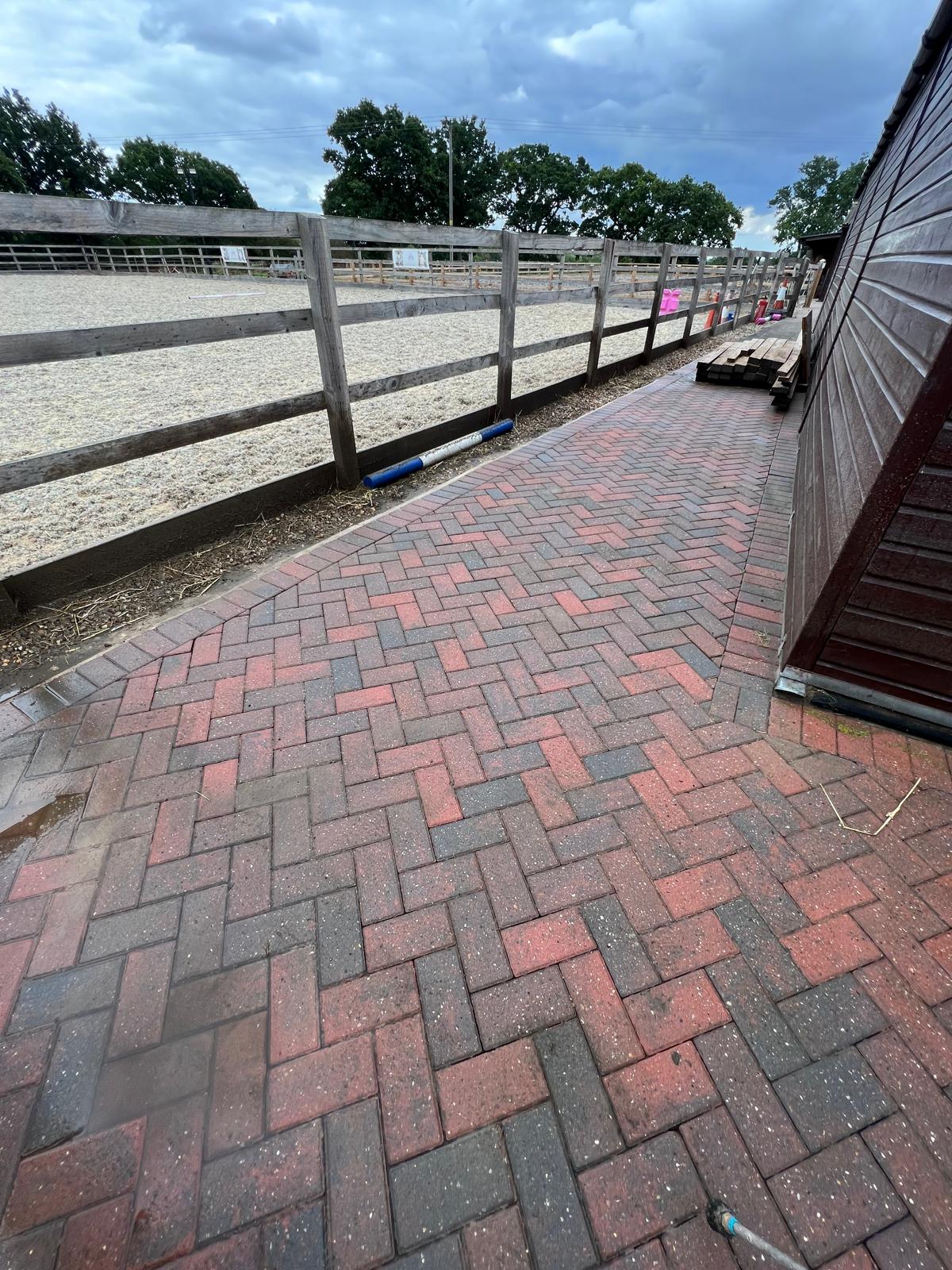 Clean block paving yard at equestrian stables after professional pressure washing