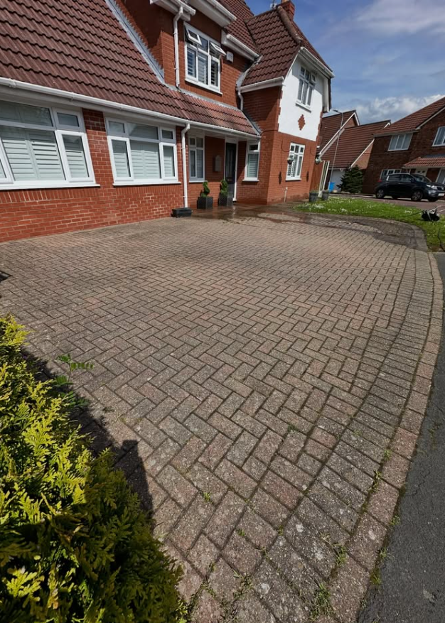 Residential block paved driveway before professional pressure washing
