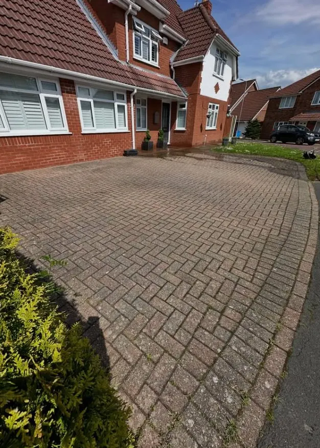 Residential block paved driveway before professional pressure washing