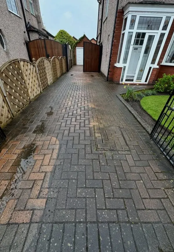 Narrow block paved side driveway after professional cleaning