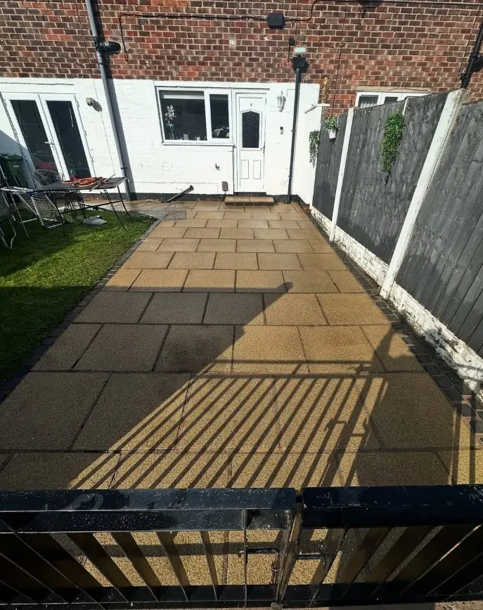 Patio paving stones restored to original golden colour after steam cleaning