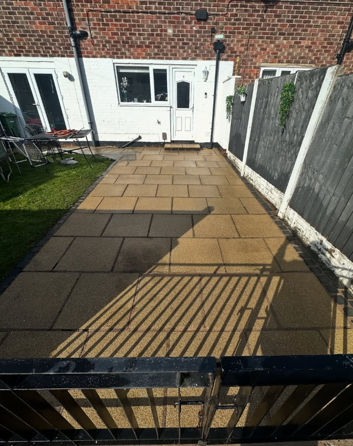 Patio paving stones restored to original golden colour after steam cleaning