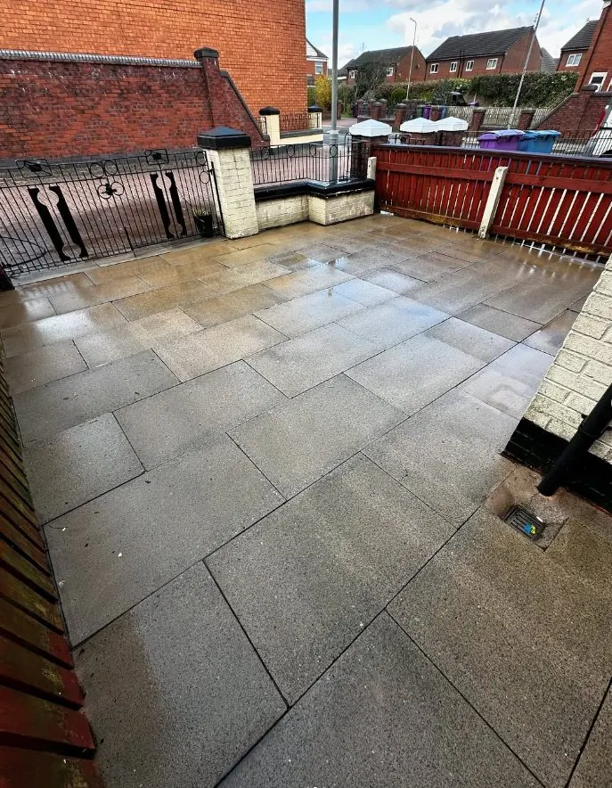 Clean grey flagstone patio after professional pressure washing