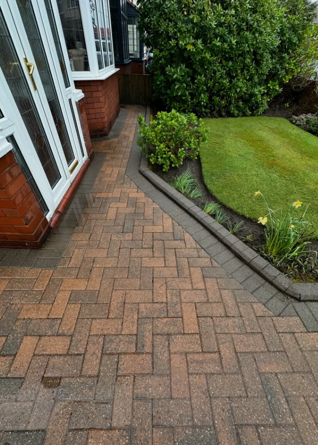 Clean block paving path restored to original colour after professional cleaning