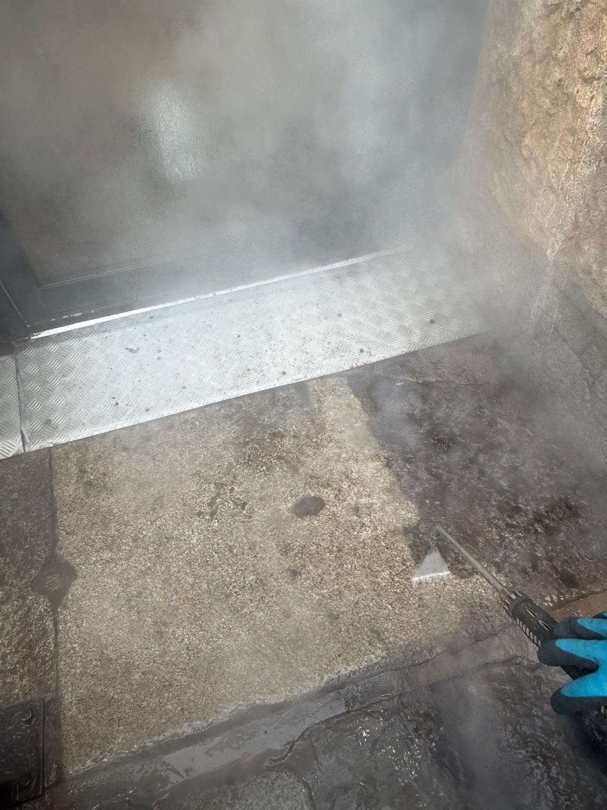 DOFF steam cleaning in action on stone steps with superheated steam visible