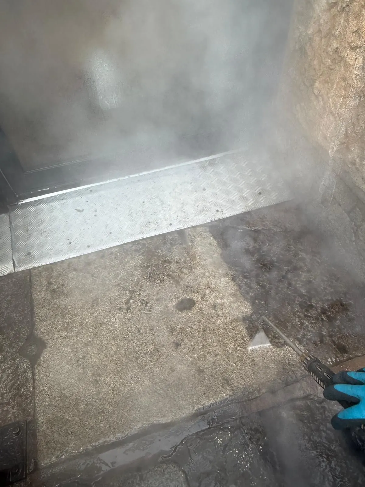DOFF steam cleaning in action on stone steps with superheated steam visible