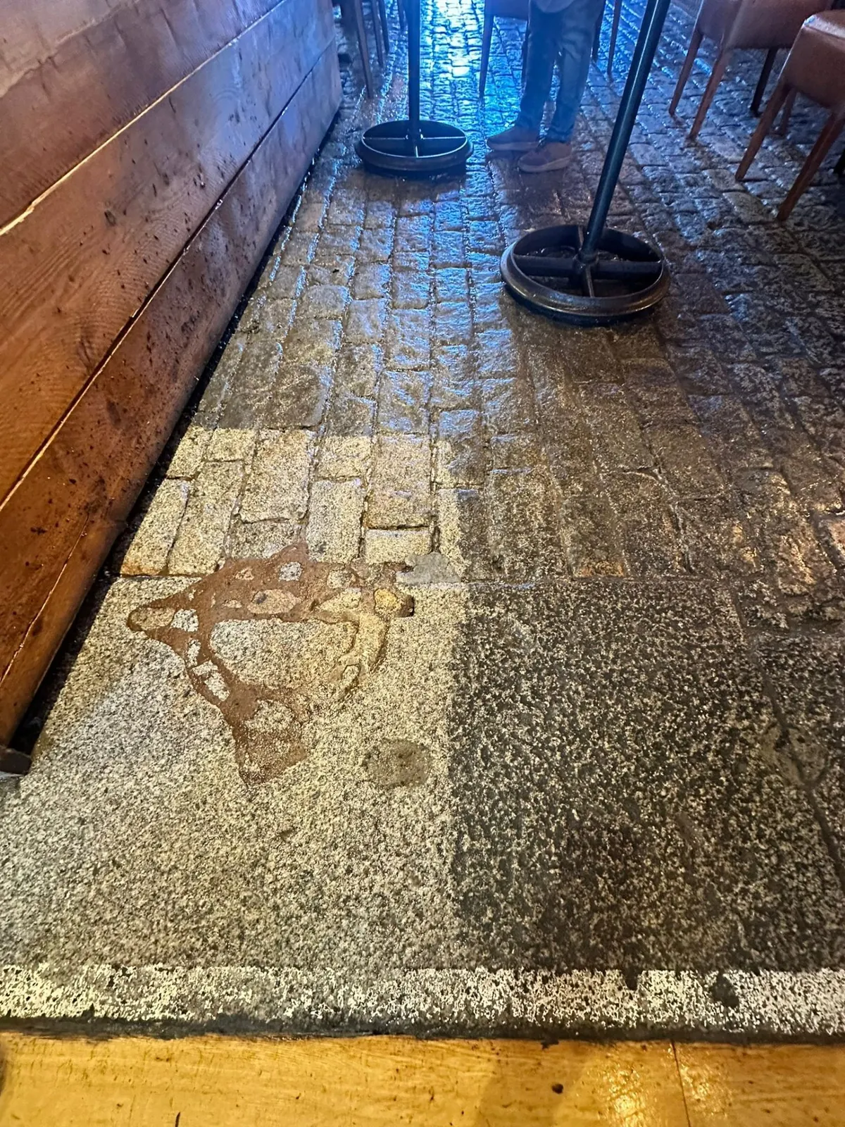 Cobblestone floor showing before and after DOFF cleaning results in a commercial venue