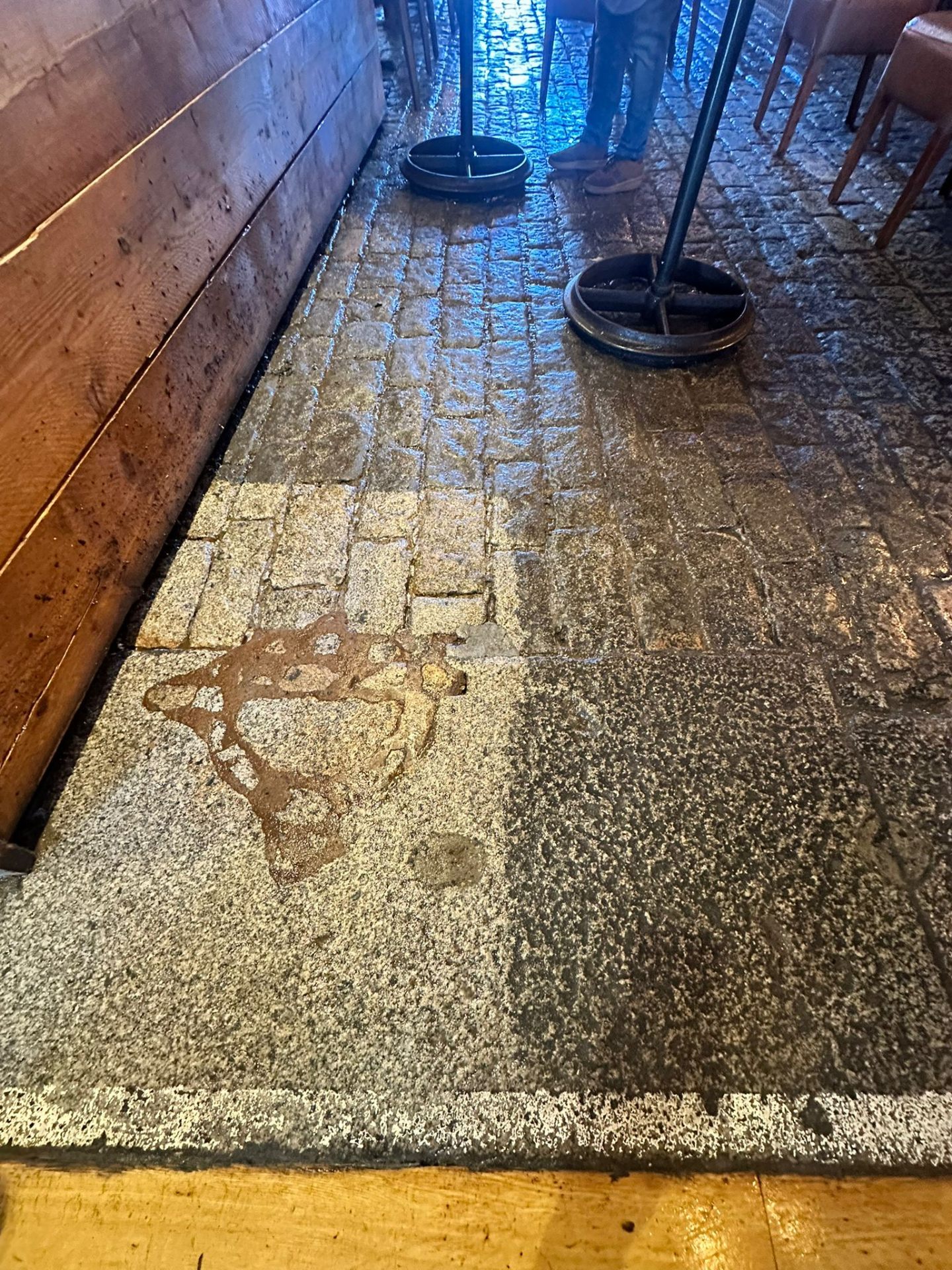 Cobblestone floor showing before and after DOFF cleaning results in a commercial venue